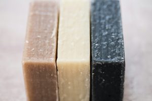 High angle close up of three bars of homemade bars of soap.