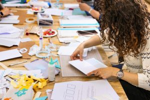 Scrap Booking Workshop. Close-up of a woman working on paper.