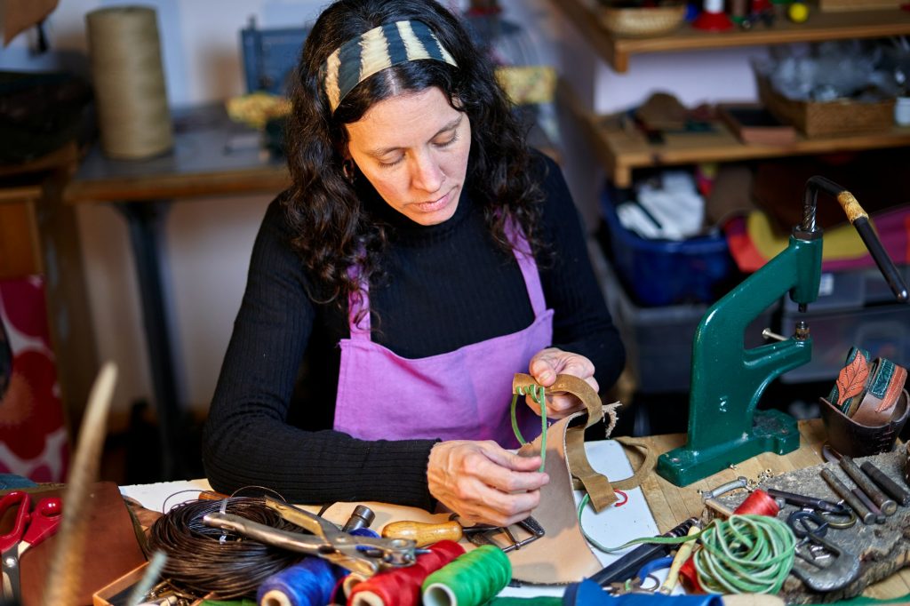 Craftswoman working leather