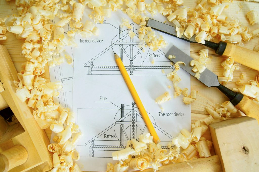 Woodworking. Drawings for building and working tools on wooden background.